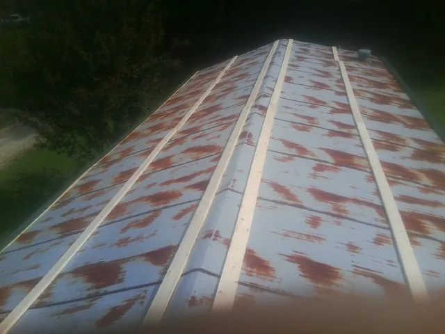 Rusted metal roof panels with new wood purlins before replacement — Storm Damage Roof Repair in Tuppers Plains by Roofing Brothers
